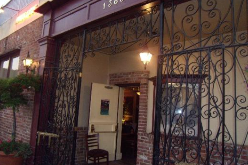 Beautifully designed metal gate in front of authentic restaurant with pleasant lightings
